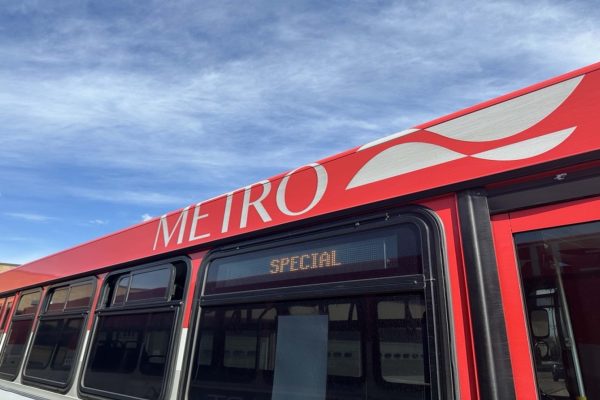 Top of the Metro bus with the word Metro and logo image in white with a red background. The word Special is in the right-side window marquee.