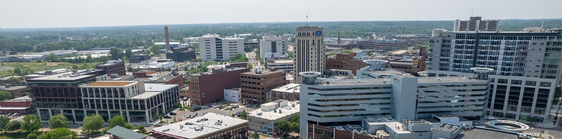 An aerial image of the city of Kalamazoo, with the exchange building, the Radisson hotel, and the Fifth Third Bank building all in view.