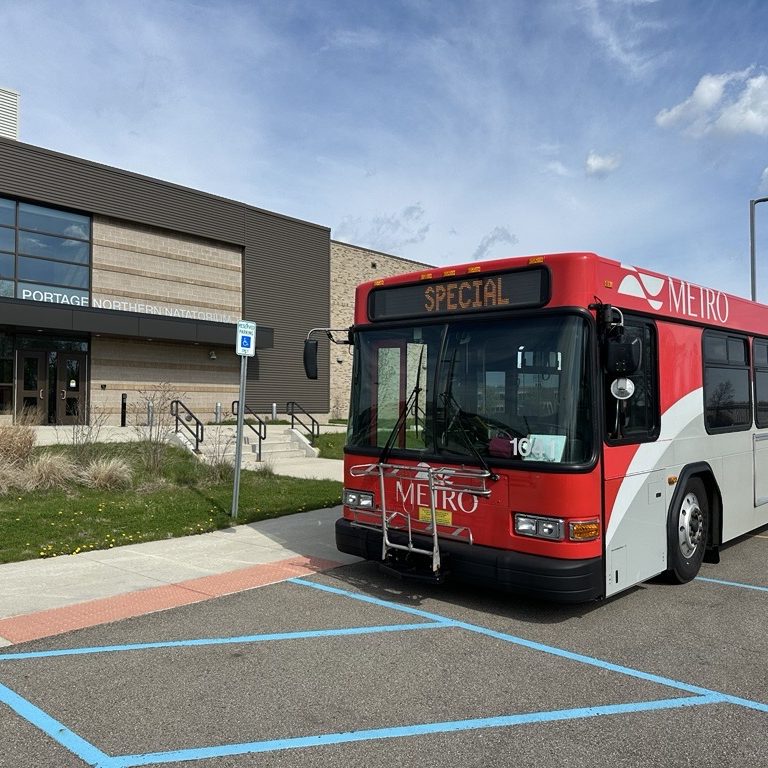 Metro Bus with the words Special on the front windshield marquee. The bus is parked in front of the Portage Northern Natatorium.