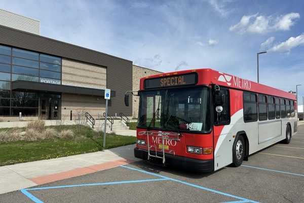 Metro Bus with the words Special on the front windshield marquee. The bus is parked in front of the Portage Northern Natatorium.