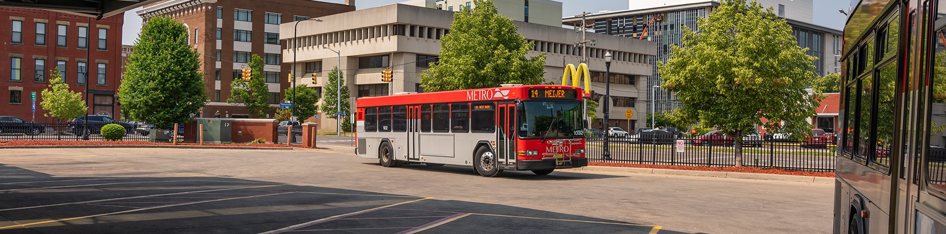 An image of a Kalamazoo Metro bus pulling into the Kalamazoo Transportation Center's bus parking.